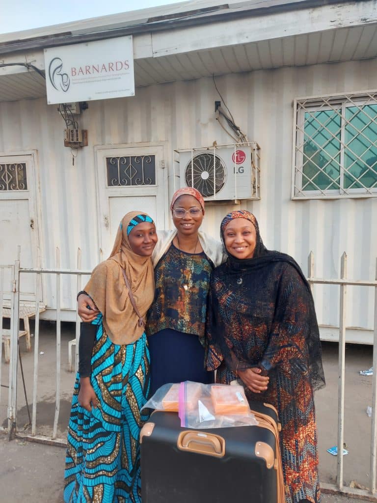 Photo of Chy and colleagues outside of a BARNARDS lab in Nigeria