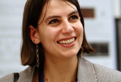Young woman wearing a blazer and smiling